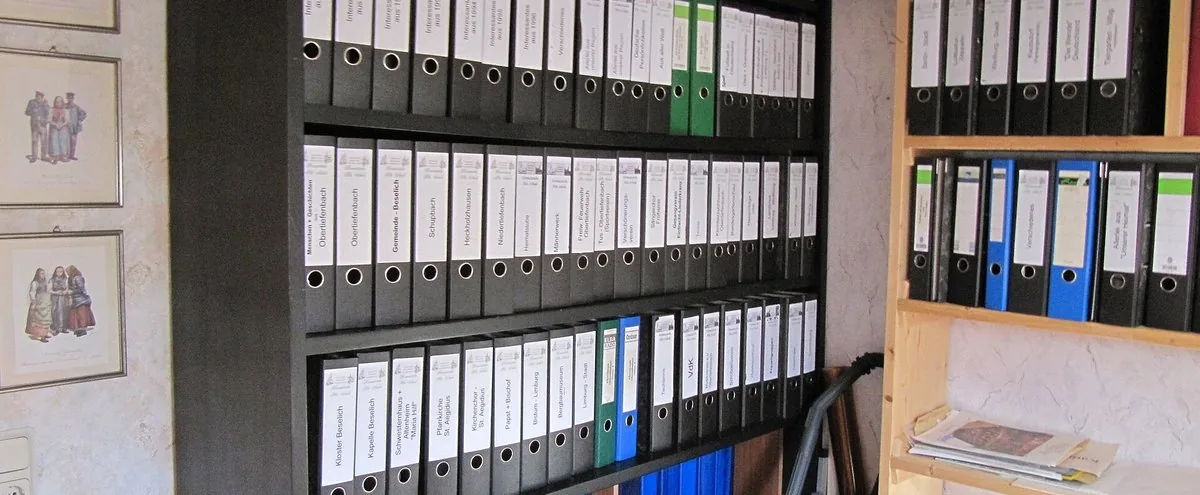 Shelves of labelled lever-arch files in an office