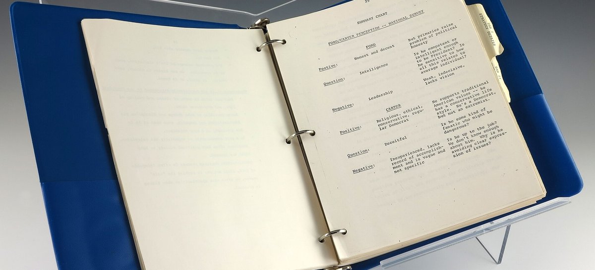 An open ring binder of typed pages on a reading stand