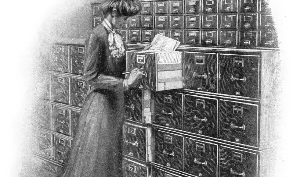 An engraving of a clerk working at a card-index cabinet